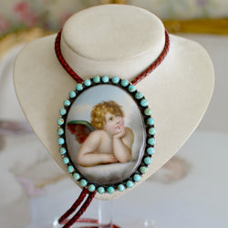 Rare Wisdom Collection 19 th. C. Porcelain Portrait Bolo Depicting Raphael's Cherub Framed in Royston Turquoise Surround