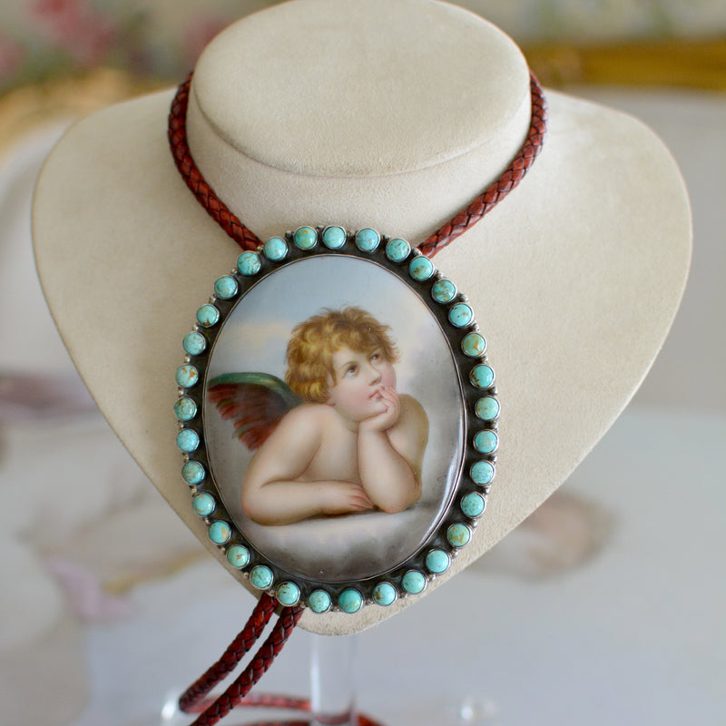 Rare Wisdom Collection 19 th. C. Porcelain Portrait Bolo Depicting Raphael's Cherub Framed in Royston Turquoise Surround