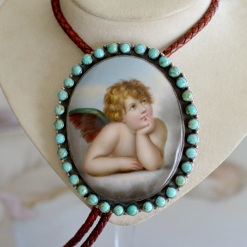 Rare Wisdom Collection 19 th. C. Porcelain Portrait Bolo Depicting Raphael's Cherub Framed in Royston Turquoise Surround