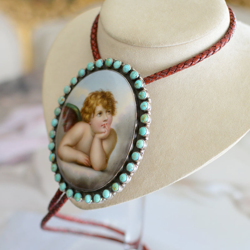 Rare Wisdom Collection 19 th. C. Porcelain Portrait Bolo Depicting Raphael's Cherub Framed in Royston Turquoise Surround