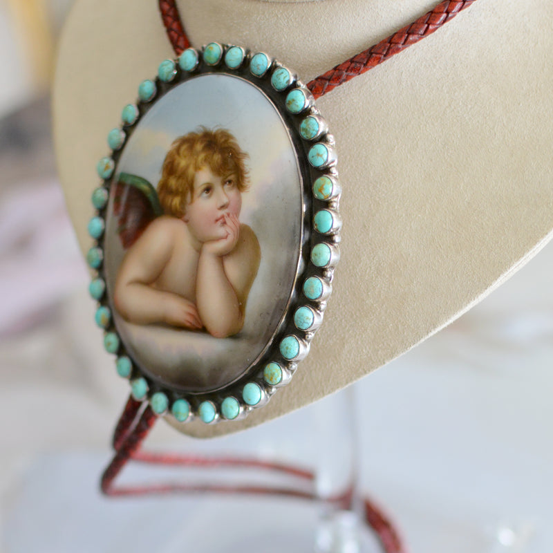 Rare Wisdom Collection 19 th. C. Porcelain Portrait Bolo Depicting Raphael's Cherub Framed in Royston Turquoise Surround